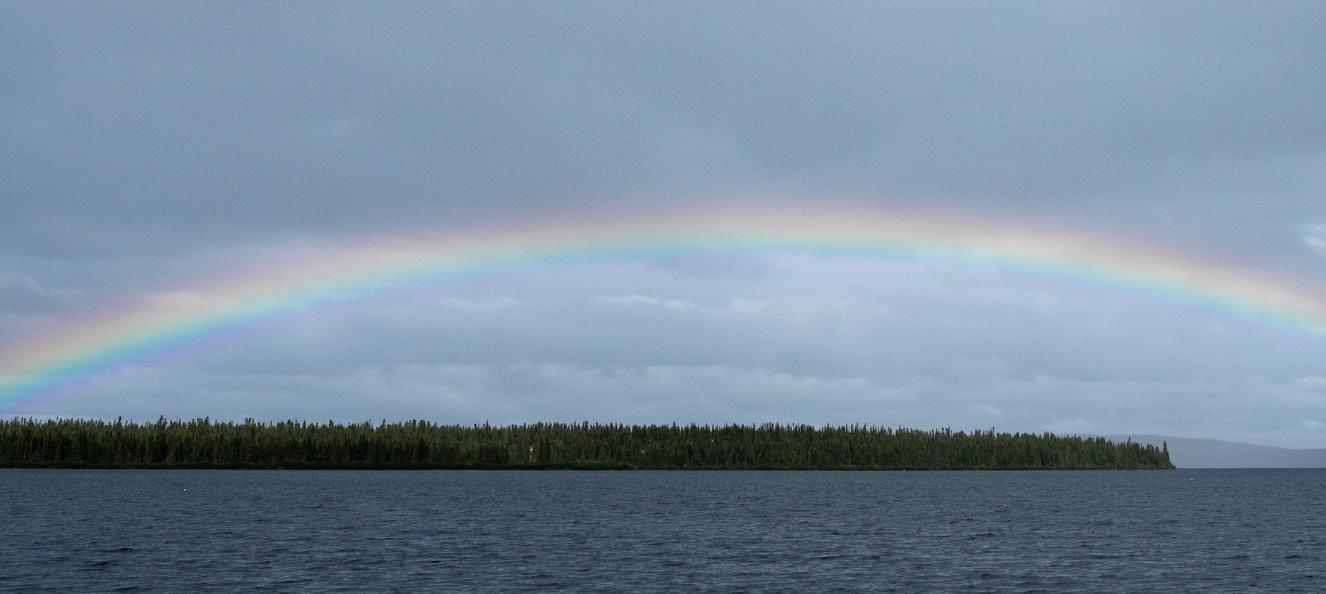 Photo of a rainbow over a lake in Naskapi.