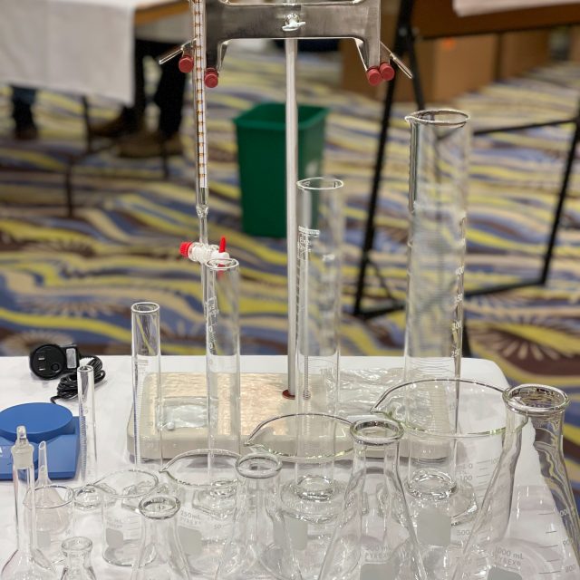 A table covered with class laboratory equipment.