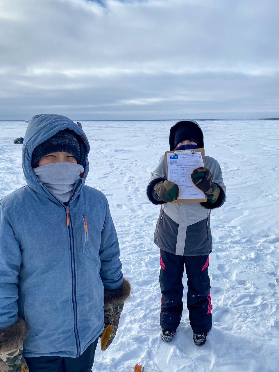On a frozen lake collecting water samples. Délı̨nę First Nation.