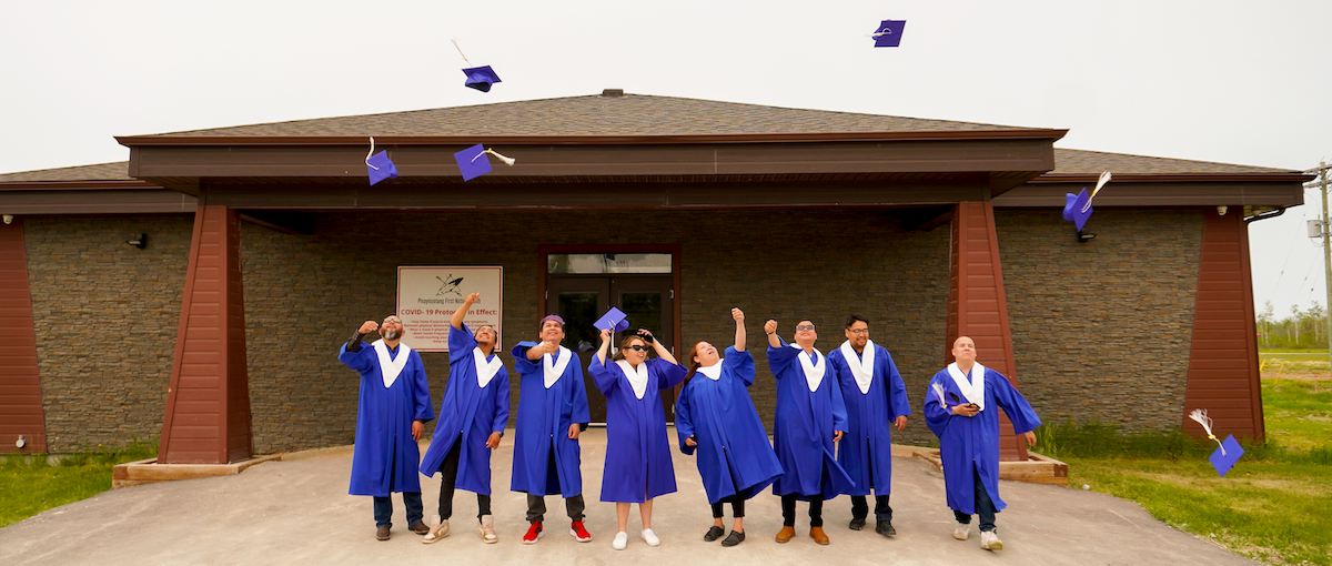 Internship graduates toss their caps in the air