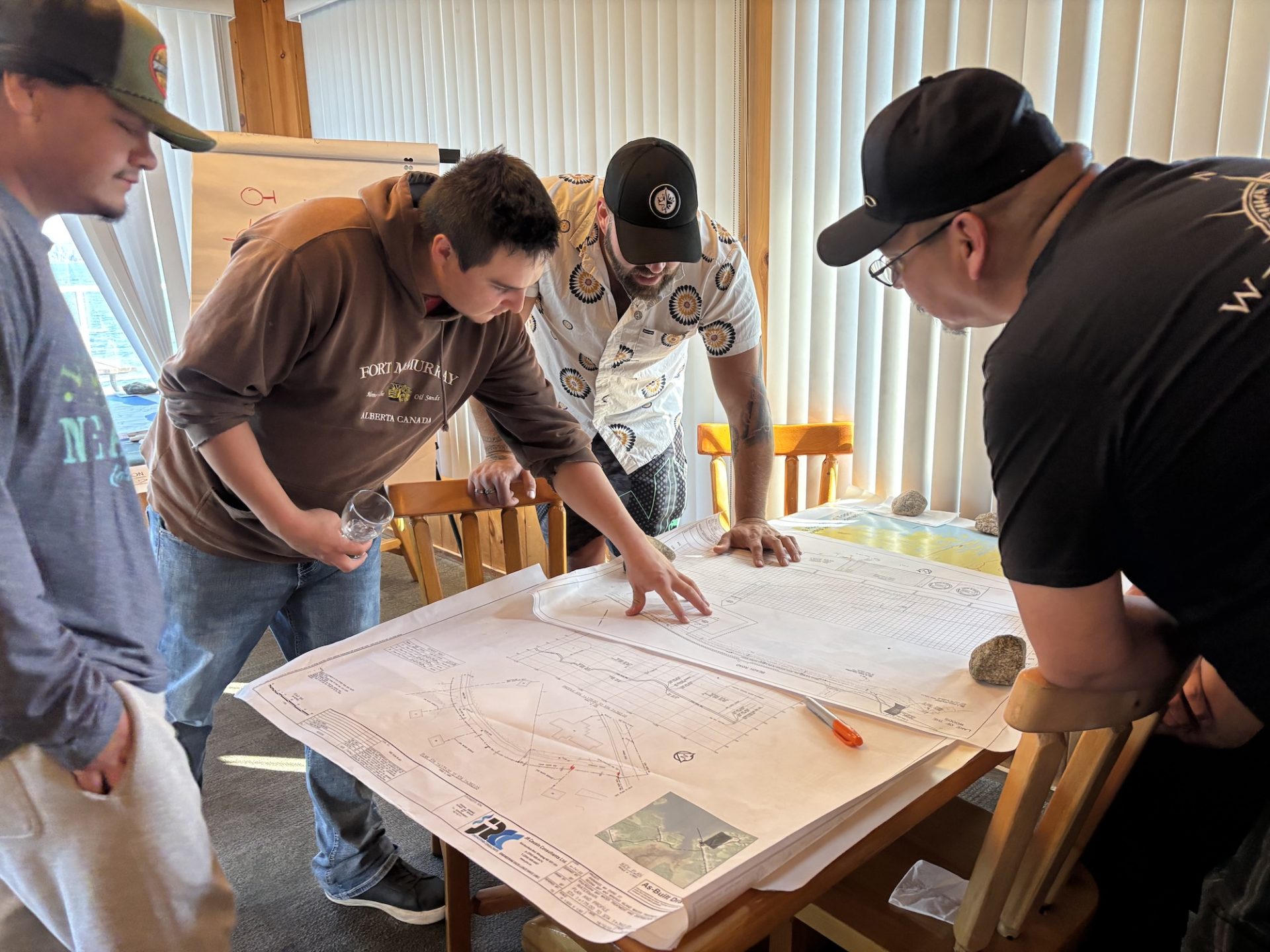 AKRC interns examine charts during a mapping and GIS workshop